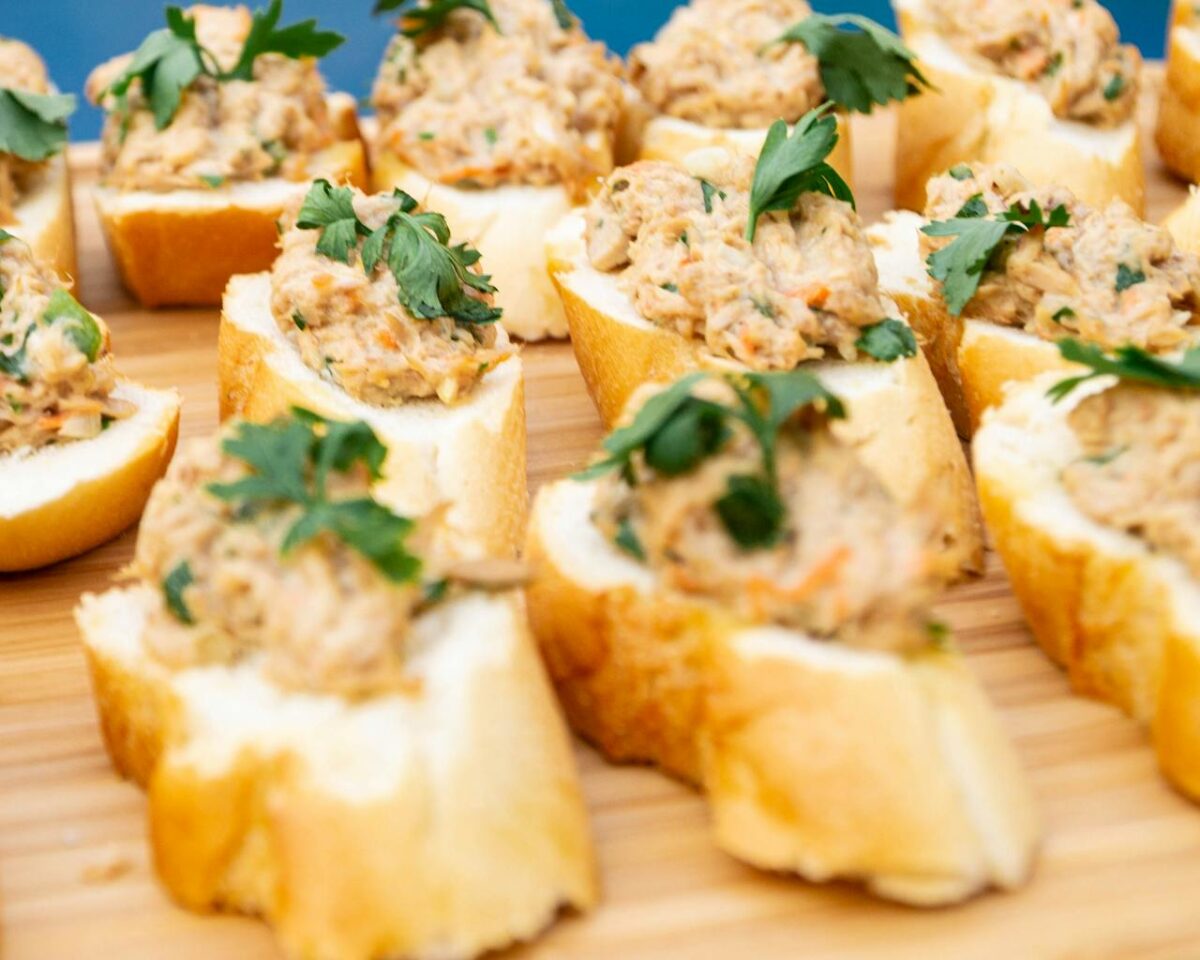 Delicious savory bread topped with a creamy spread and fresh parsley, perfect for appetizers and parties.
